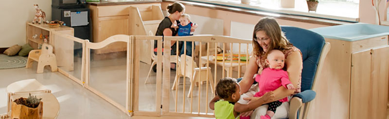 Teachers and children playing in a classroom