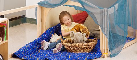 child holding a stuffed animal