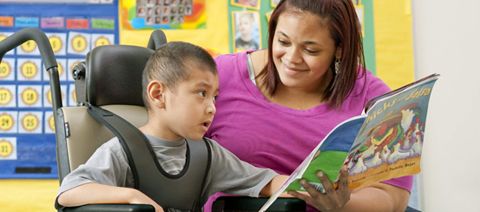 teacher reading a book to a child