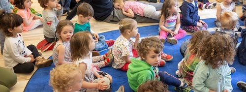 children sitting on a mat