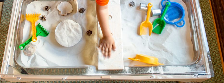 Sensory table with sand and loose parts