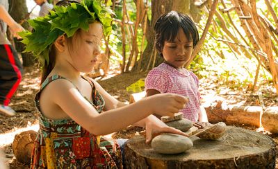 girl playing with rocks and shells