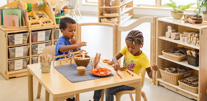 preschool kids playing with loose parts at a table