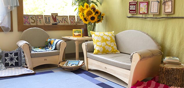 A cosy classroom corner furnished with sofas.